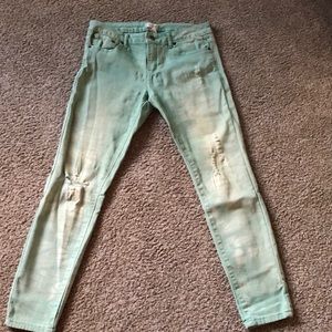 Mint green distressed skinny jeans